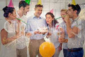 Composite image of casual businessmen team celebrating a birthda