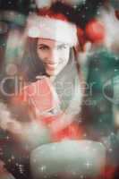 Composite image of festive brunette pressing gift at christmas