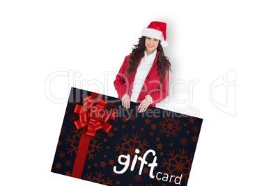 Composite image of cheerful brunette showing gift card