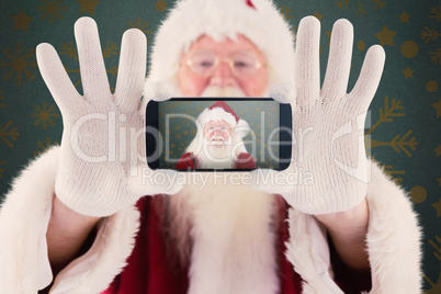 Composite image of santa records himself with a smartphone