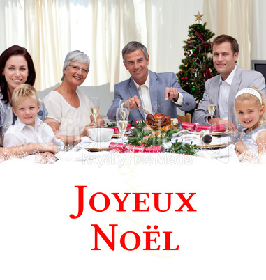 Composite image of family eating turkey in christmas eve dinner