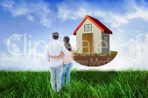 Composite image of attractive young couple standing with arms ar