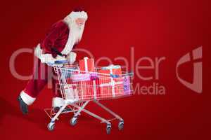 Composite image of santa rides on a shopping cart