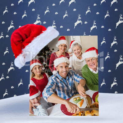 Composite image of father in santa hat carving chicken at christ