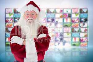 Composite image of santa smiles with folded arms