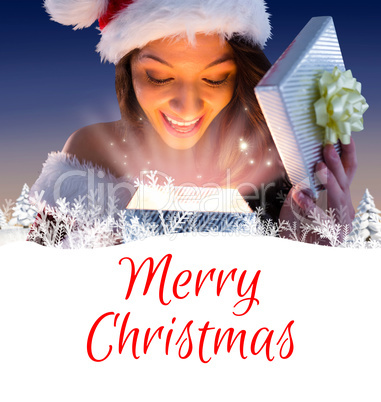 Composite image of sexy santa girl opening gift