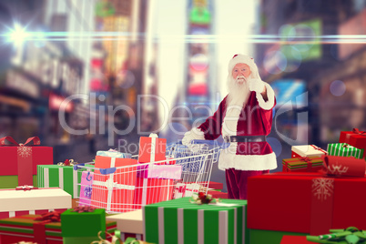 Composite image of santa delivering gifts from cart