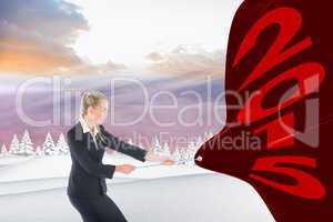 Composite image of focused blonde businesswoman pulling a rope