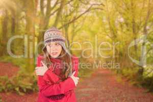 Composite image of cold redhead wearing coat and hat