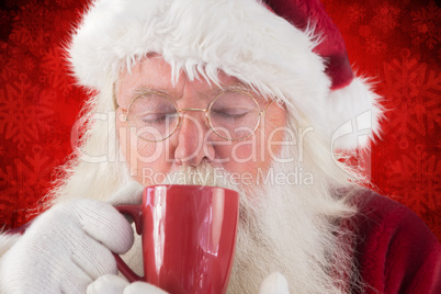 Composite image of santa drinks from a red cup
