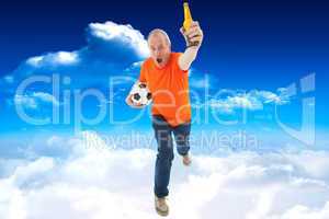 Composite image of mature man in orange tshirt holding football