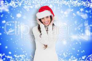 Composite image of festive brunette smiling at camera