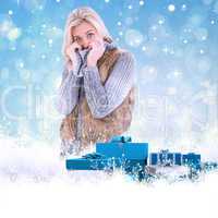 Composite image of blonde in winter clothes smiling at camera