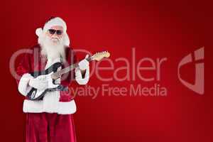 Composite image of santa claus plays guitar with sunglasses