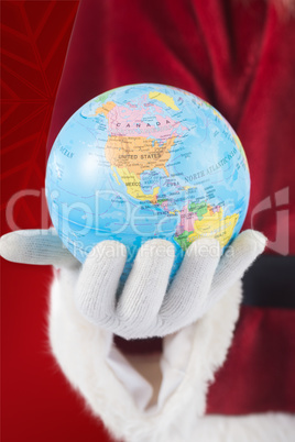 Composite image of santa has a globe in his hand Composite image of santa has a globe in his hand