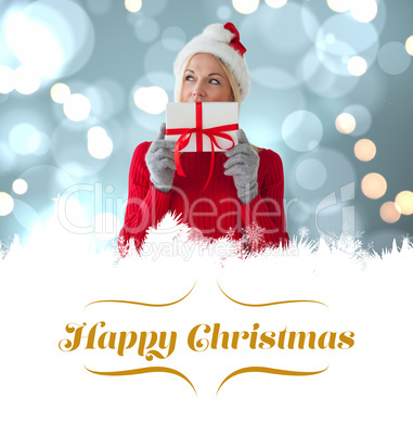 Composite image of happy festive blonde with gift