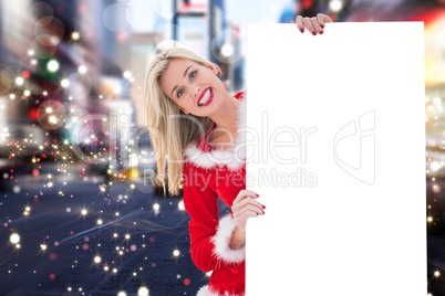 Composite image of festive blonde showing white card