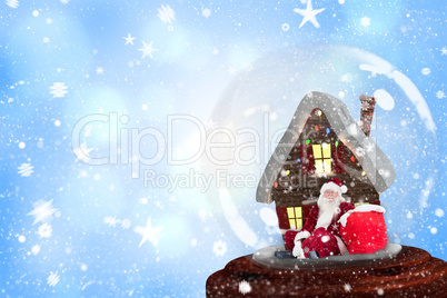 Composite image of santa sitting in snow globe