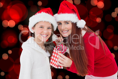 Composite image of mother and daughter with gift