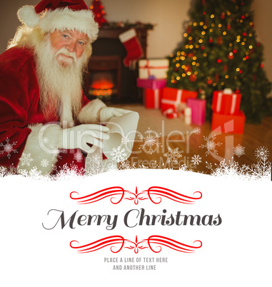 Composite image of smiling santa claus holding a scroll