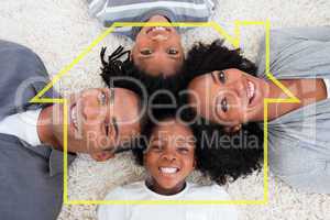 Composite image of family on floor with heads together