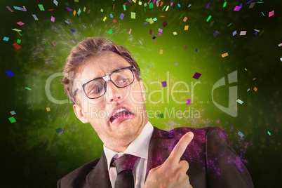 Composite image of young geeky businessman pointing to shoulder