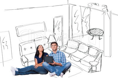 Composite image of young couple sitting on floor with tablet