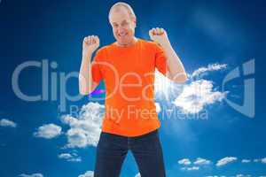 Composite image of mature man in orange tshirt cheering