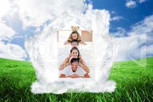 Composite image of young family playing on bed together