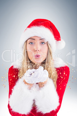 Pretty santa girl blowing over hands