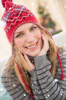 Composite image of portrait of a smiling pretty blonde in winter hat