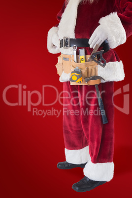 Composite image of father christmas is wearing a tool belt