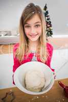 Composite image of festive little girl making christmas cookies