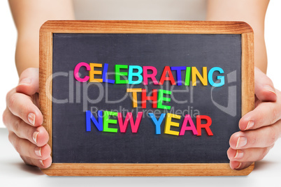 Composite image of females hands showing black board