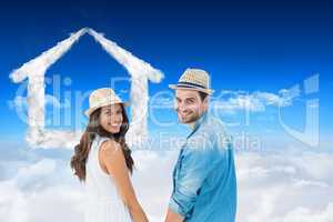 Composite image of happy hipster couple holding hands and smilin