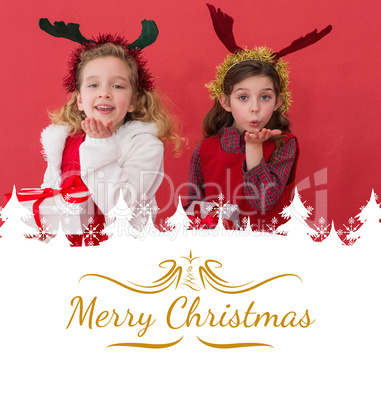 Composite image of festive little girls holding gifts