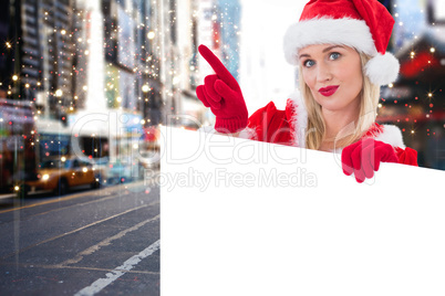 Composite image of festive blonde showing white card