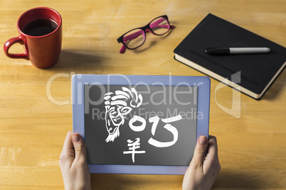 Composite image of businesswoman using tablet at desk