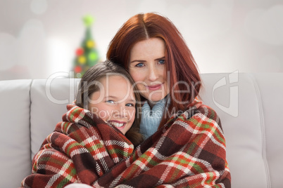 Composite image of mother and daughter under blanket