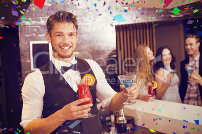 Composite image of handsome barman smiling at camera holding coc