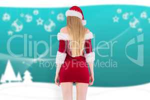 Composite image of festive blonde standing rear view