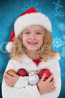 Composite image of festive little girl smiling at camera