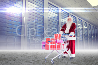 Composite image of santa delivering gifts from cart