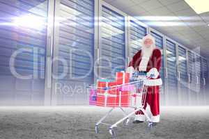 Composite image of santa delivering gifts from cart