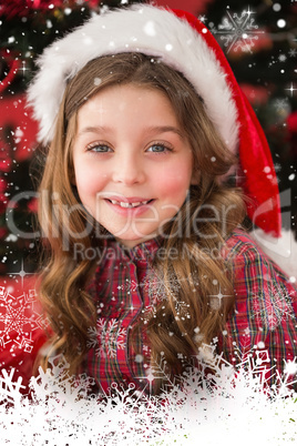 Composite image of festive little girl smiling at camera