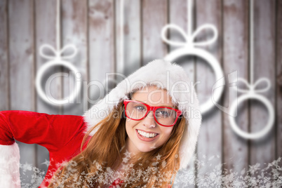 Composite image of festive redhead smiling at camera