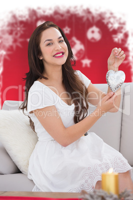 Composite image of pretty brunette with decoration