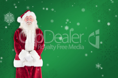 Composite image of jolly santa smiling at camera