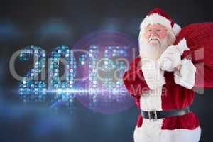 Composite image of santa carries his red bag and smiles