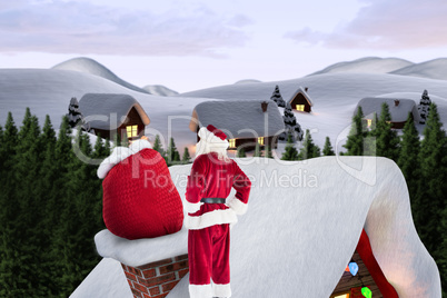 Composite image of santa on cottage roof